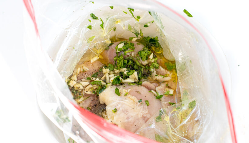 Raw chicken in a zip bag with the marinade.