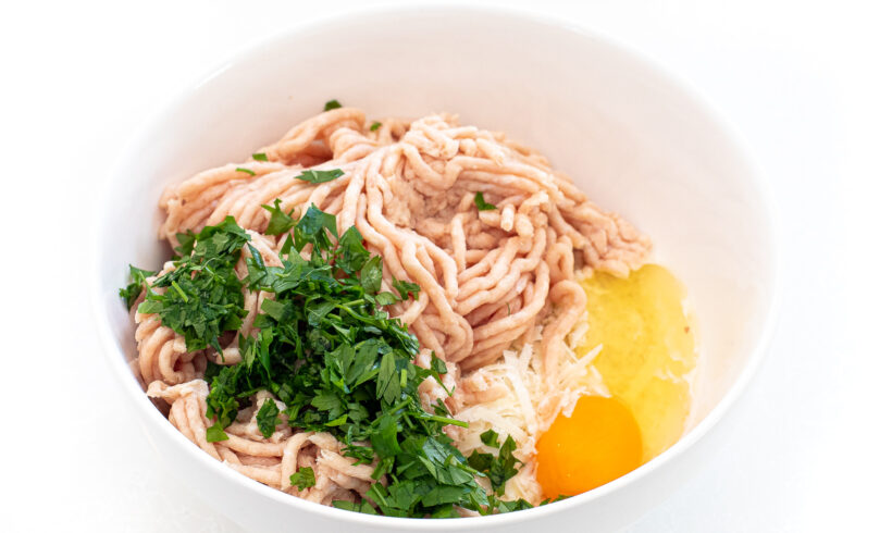 Ground chicken and other ingredients in mixing bowl. 