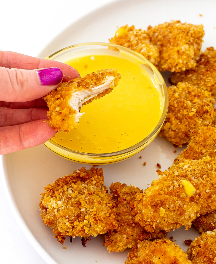author taking a bite out of chicken nuggets