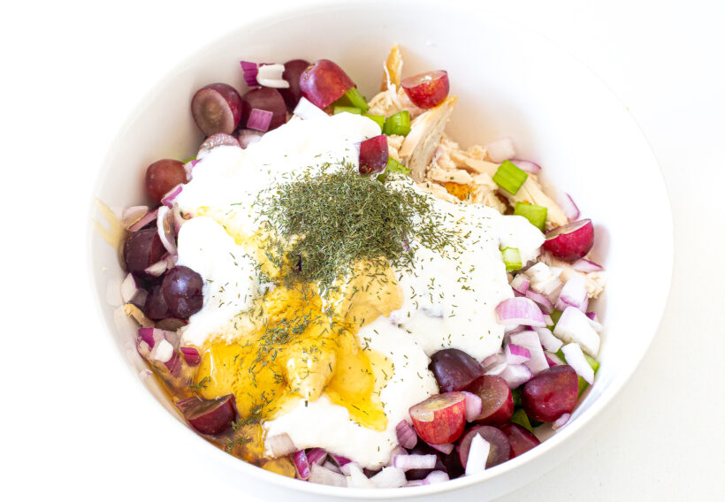 Ingredients for Greek yogurt chicken salad in a bowl before being mixed. 