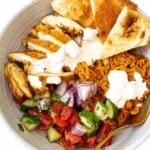 Chicken shawarma bowl with veggies, rice, chicken and naan.