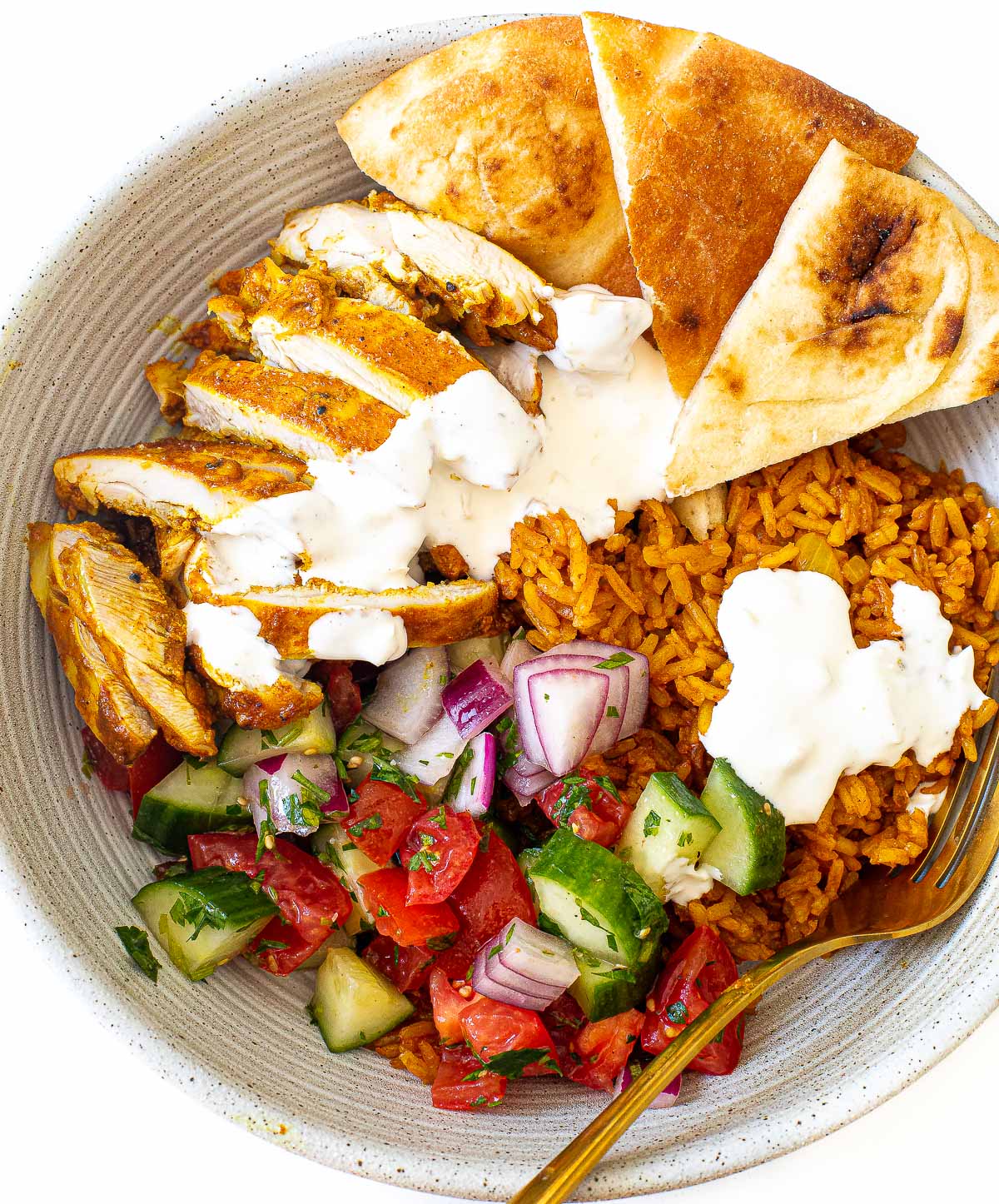 Chicken shawarma bowl with veggies, rice, chicken and naan.