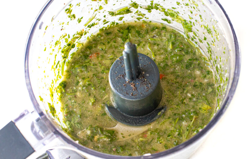 Chimichurri ingredients blended in a food processor.