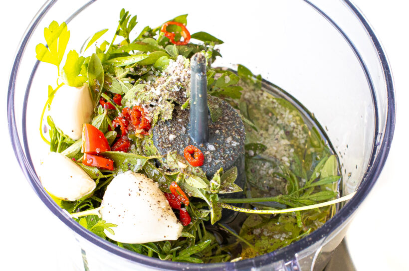 Chimichurri ingredients in a food processor.