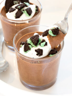 Mint Chocolate Mousse in glass cups with peppermint whipped cream and chopped mint oreos | chefsavvy.com