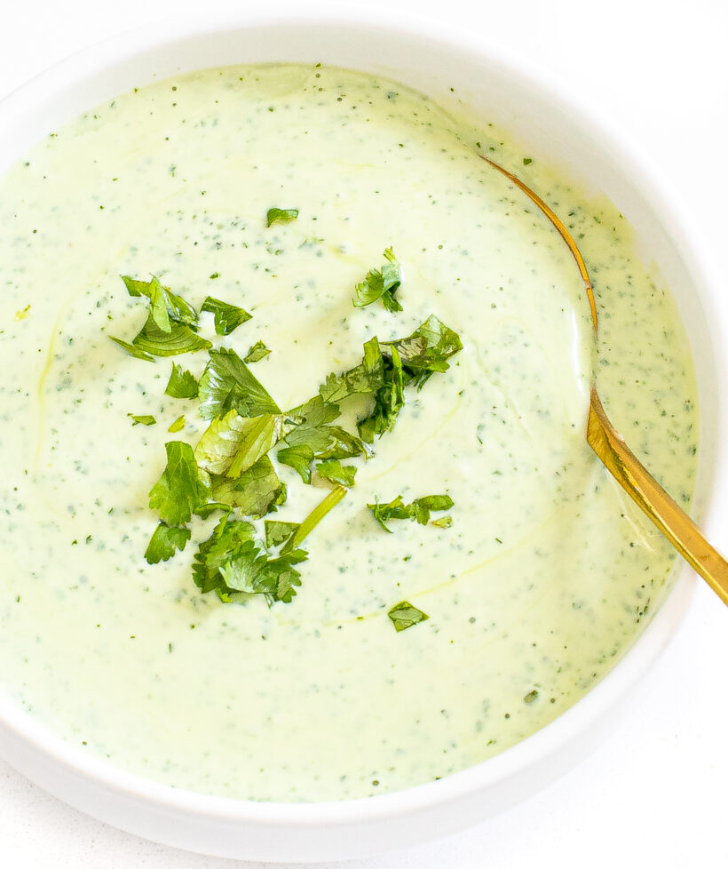 Overhead shot of cilantro yogurt sauce in a white bowl. 