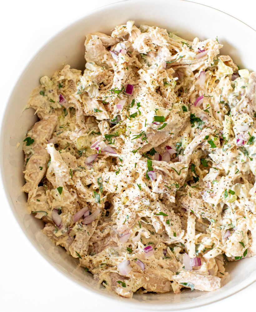 Chicken salad in a white bowl.