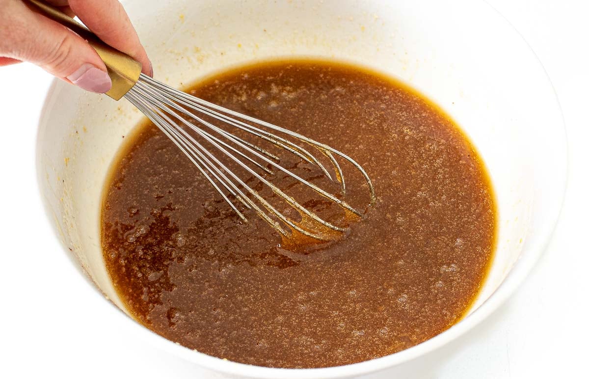 whisking ingredients in white bowl