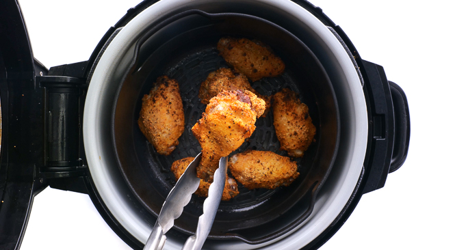 removing cooked chicken wings from the air fryer