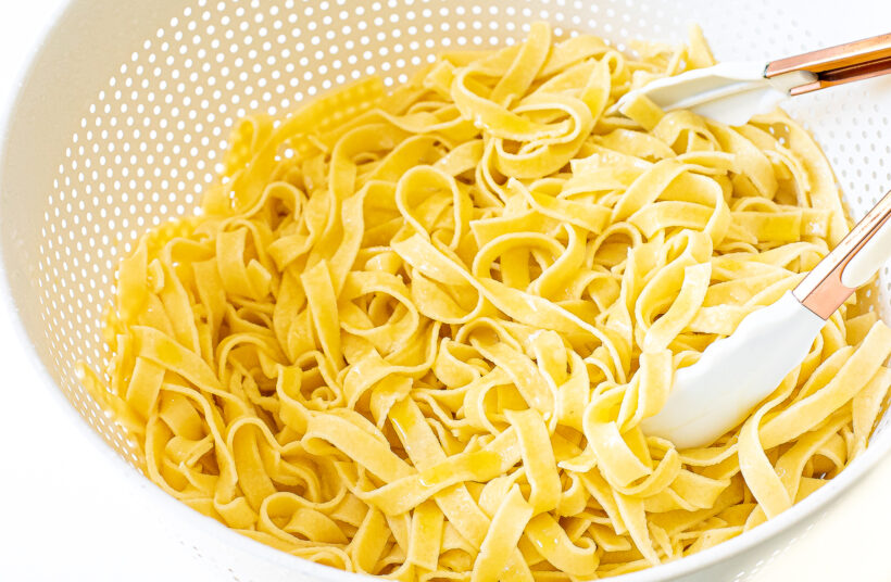 Homemade pasta in a strainer.