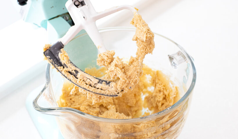 Cookie dough after adding eggs and vanilla in a stand mixer.