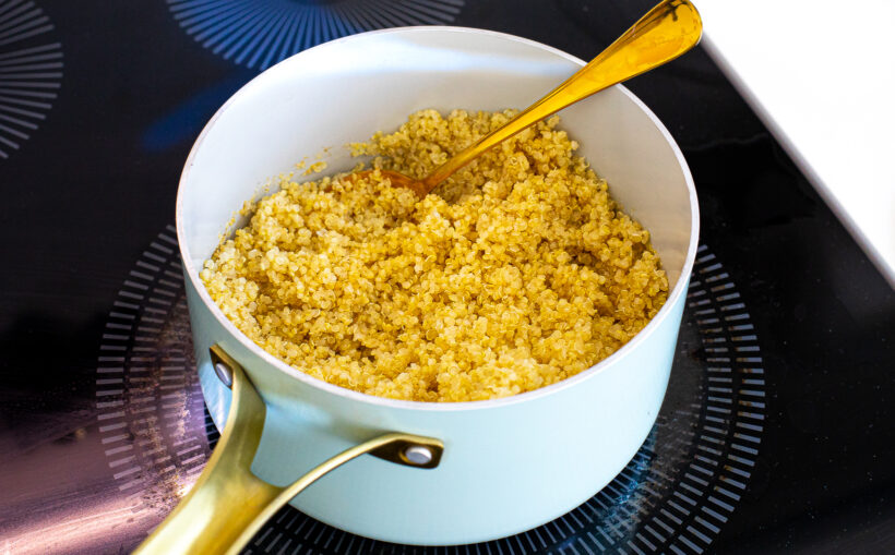 Quinoa cooking in a saucepan on the stove. 