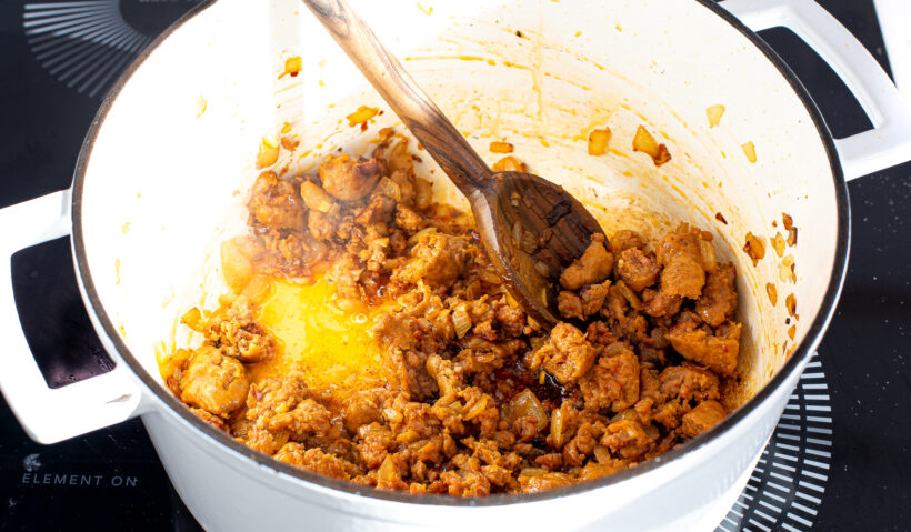 browning sausage in cast iron pot