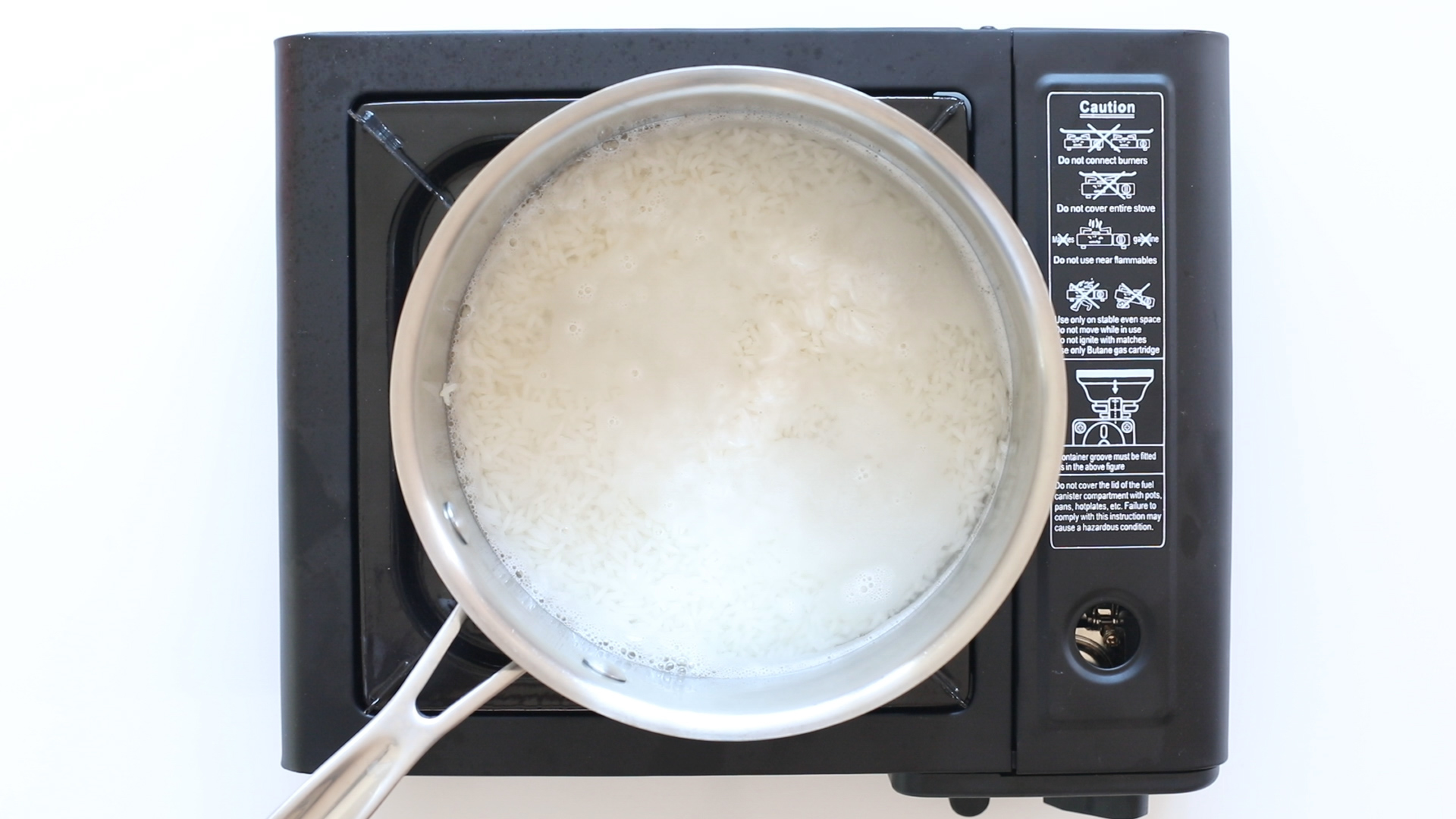 boiling rice in saucepan