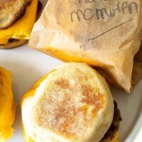 homemade English muffins topped with breakfast sausage egg and melted cheese
