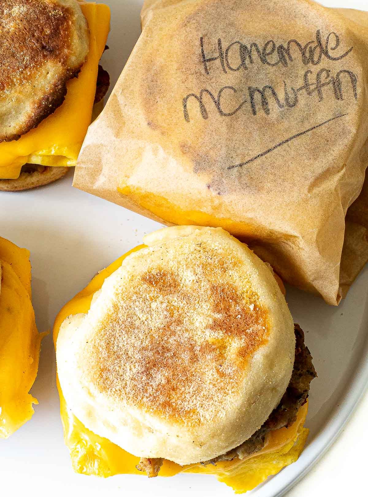 homemade English muffins topped with breakfast sausage egg and melted cheese