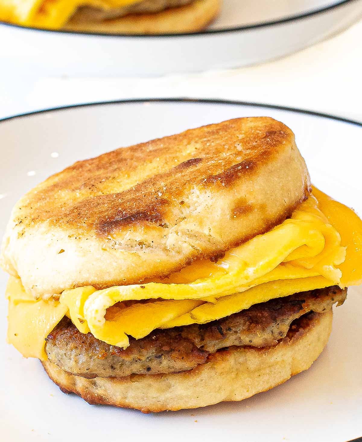 homemade sausage egg and cheese mcmuffin on a plate