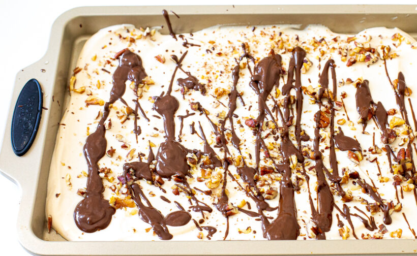 Cottage cheese mixture on a baking sheet drizzled with chocolate before freezing.