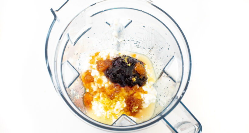 Ingredients for blueberry cottage cheese ice cream in a blender. 