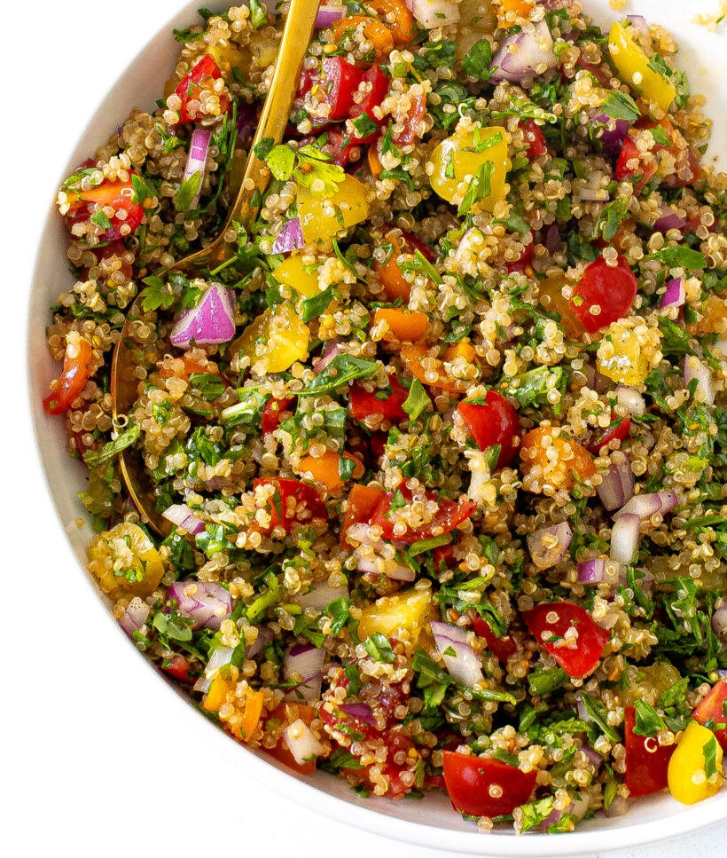 Overhead shot of tabbouleh salad in a serving bowl with a serving spoon.