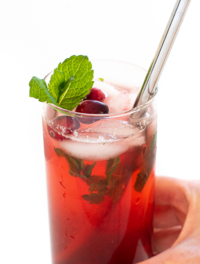 hand holding cranberry mojitos