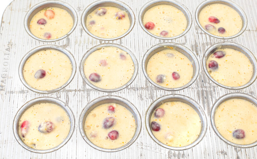 Cranberry batter in the muffin tin cups.