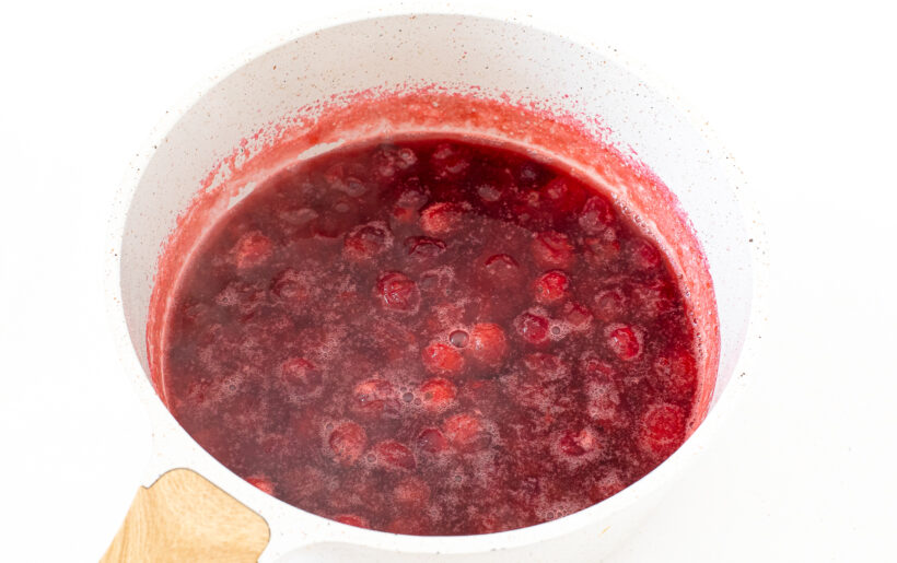 simmering cranberry sauce in saucepan