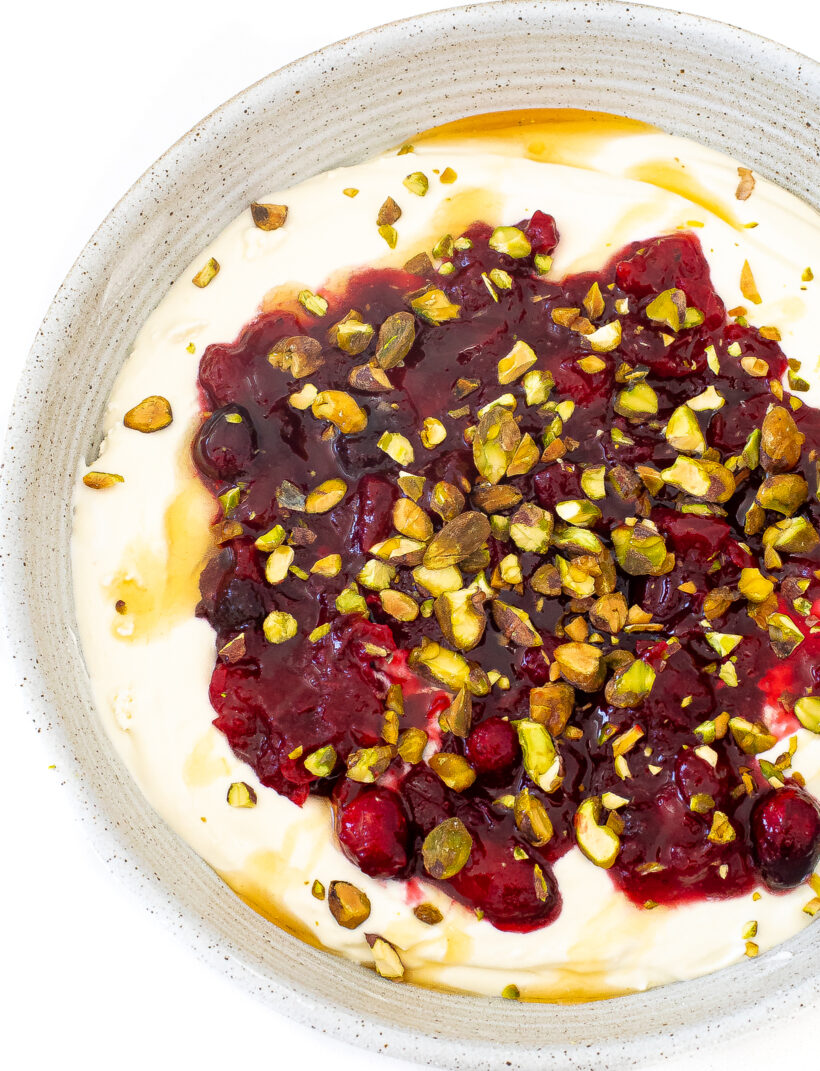 A speckled bowl full of cranberry feta dip.