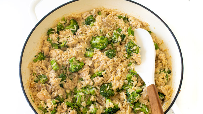 Chicken, rice and broccoli in a pan after being cooked. 