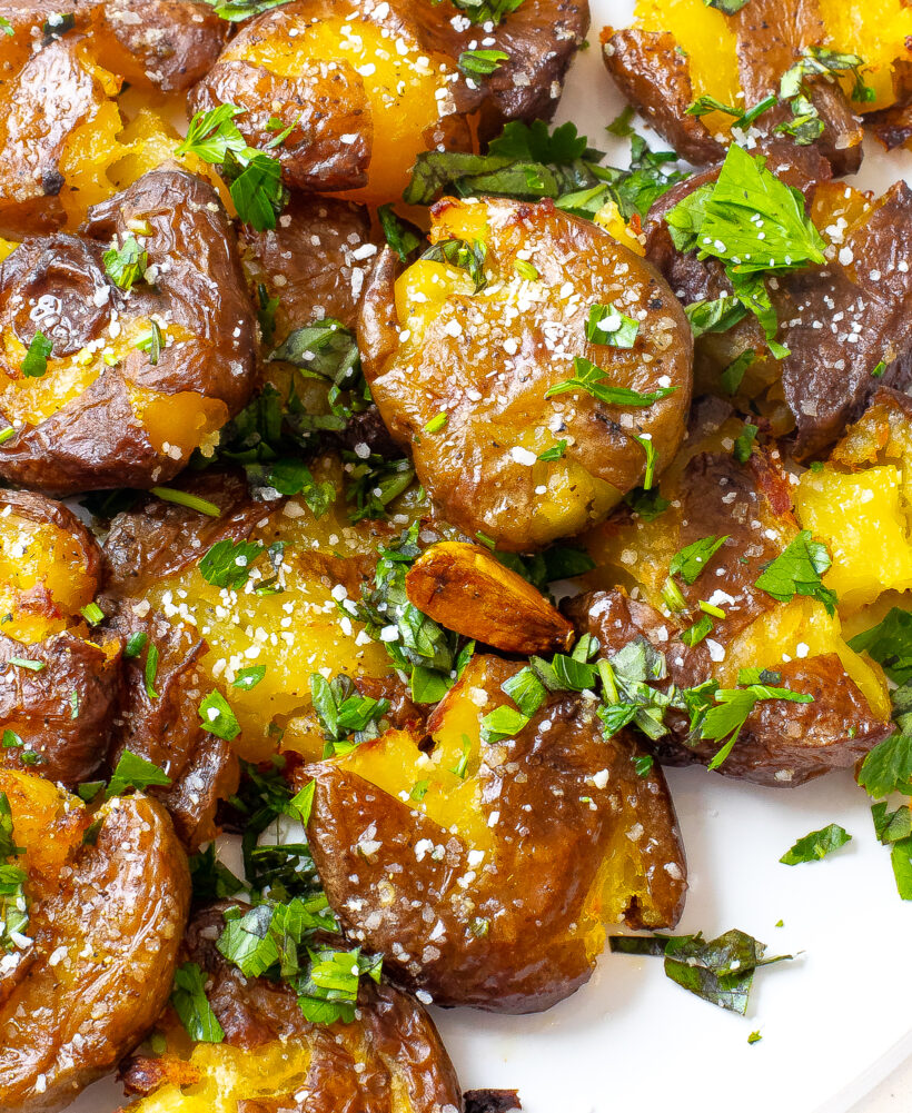 Crispy herb smashed potatoes on a plate. 