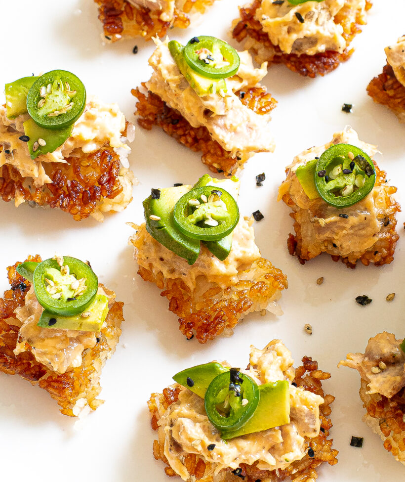 Crispy rice tuna stacks served on a white plate. 