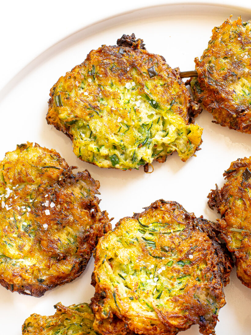 Zucchini fritters on a white plate.