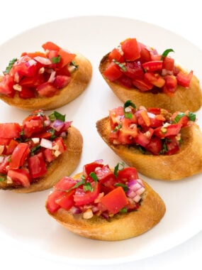 five bruschetta toasts topped with an Italian-style tomato mixture on top | chefsavvy.com
