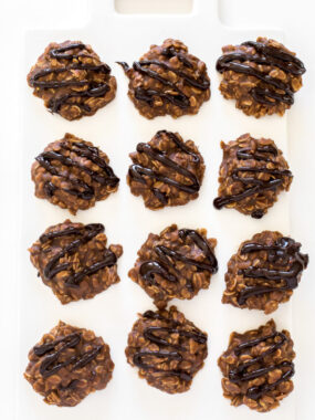Top shot of no bake chocolate cookies in rows on white cutting board.