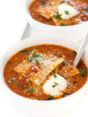 top shot of lasagna soup in white bowl with spoon