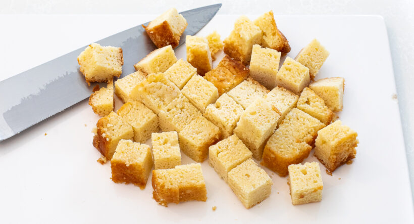cubed pound cake on white cutting board