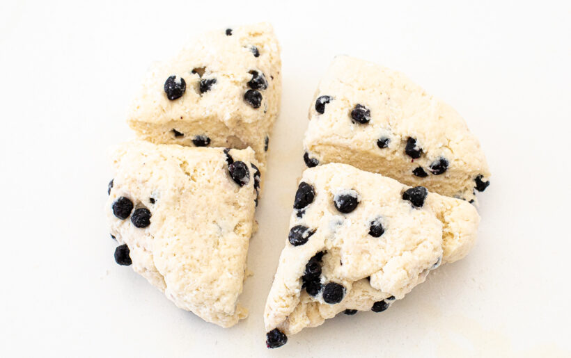 Blueberry bagel dough cut into four pieces.