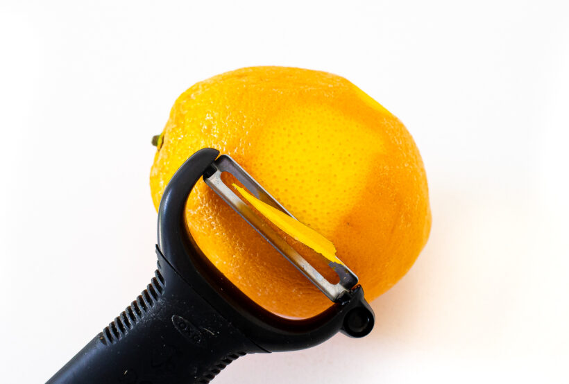 peeling orange curls with a peeler