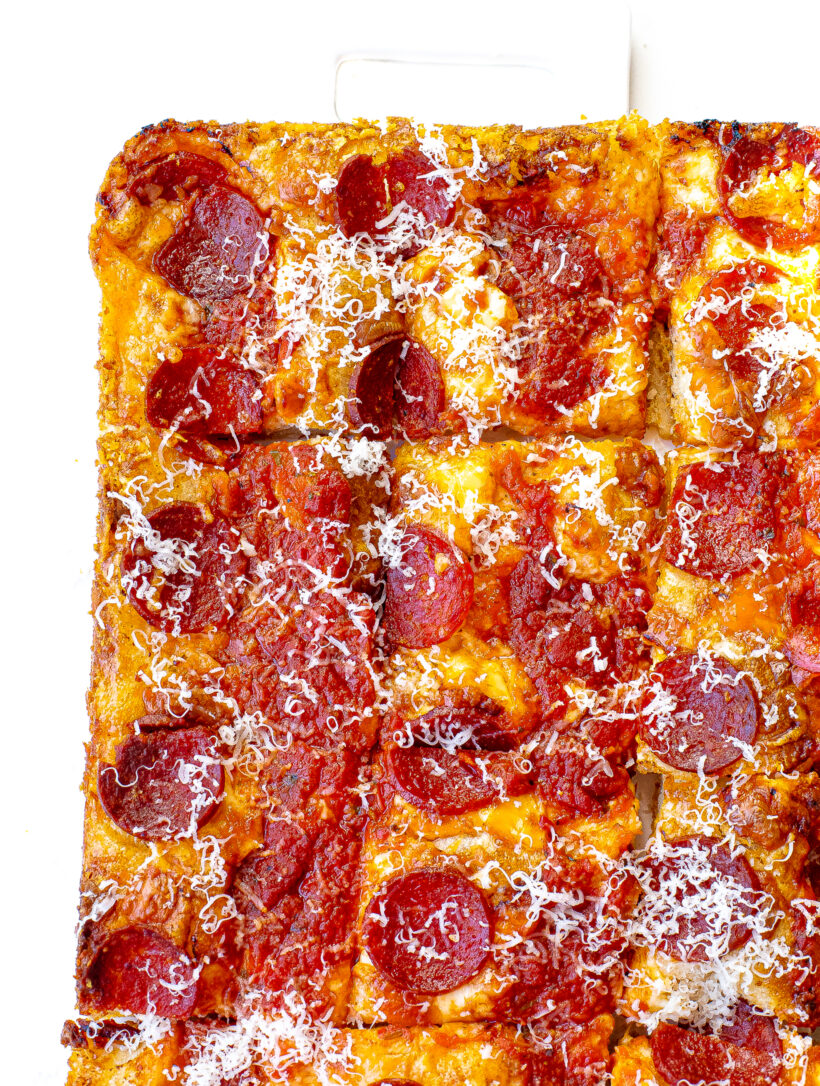 Baked Detroit style pizza cut into slices.