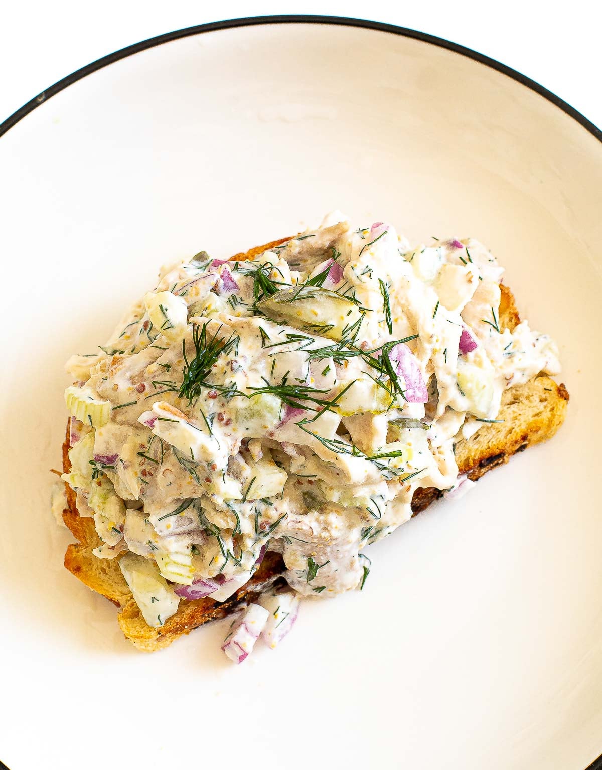 dill pickle chicken salad on top of toasted sourdough bread