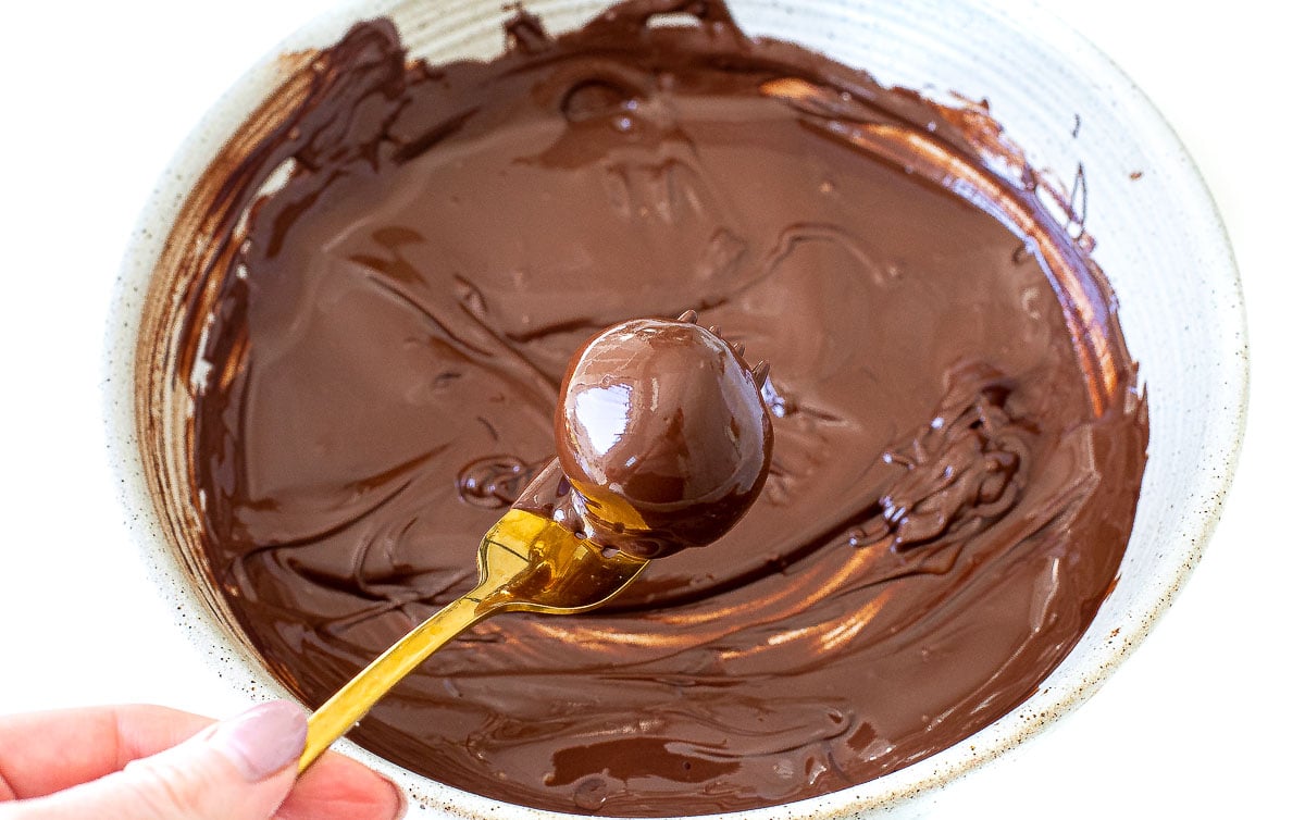 dipping energy balls in melted chocolate