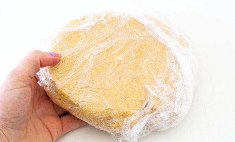 Tart dough wrapped in plastic wrap.