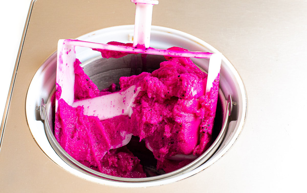 Dragon fruit water ice churning in an ice cream maker.