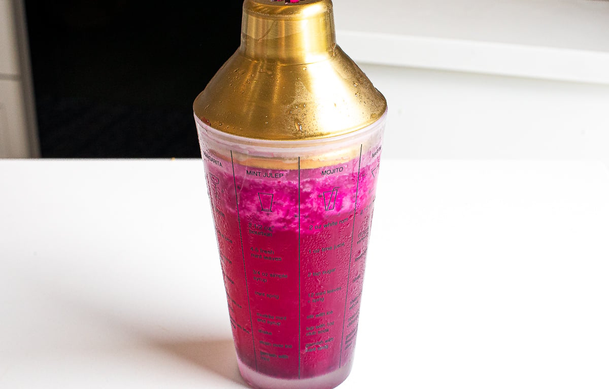 Vibrant dragon fruit cocktail in a cocktail shaker.