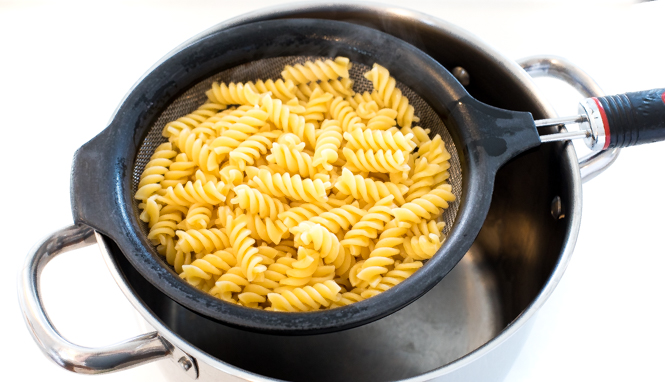 draining rotini noodles in colander