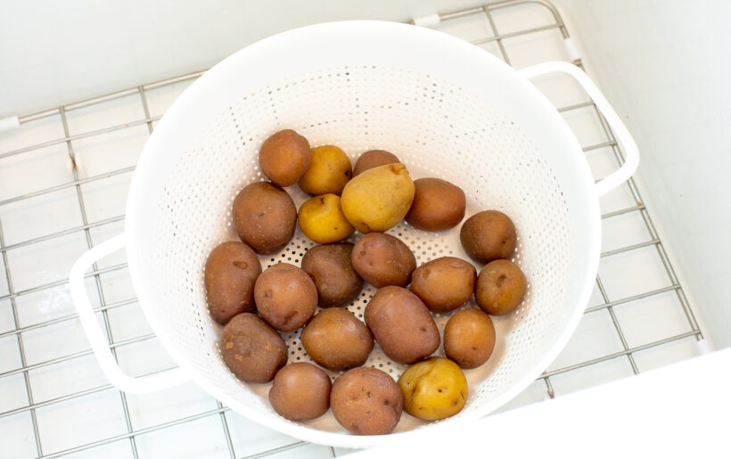 Potatoes draining in a colander.