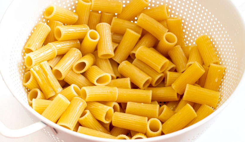 Cooked pasta in a colander. 