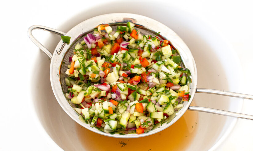 The pickle de gallo added to a strainer to strain out the brine.