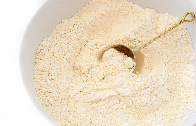 Dry ingredients for muffins in a white mixing bowl.