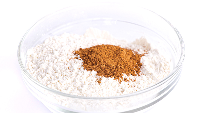 cinnamon, flour and baking powder in clear bowl